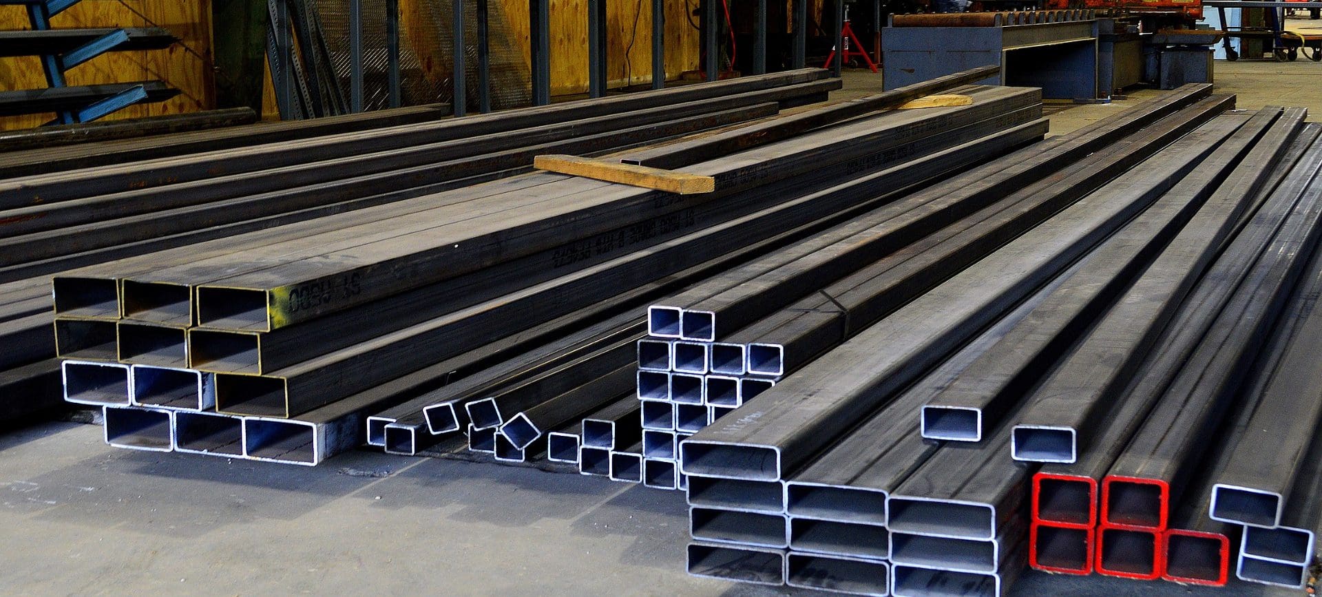 A bunch of metal pipes sitting in a warehouse.