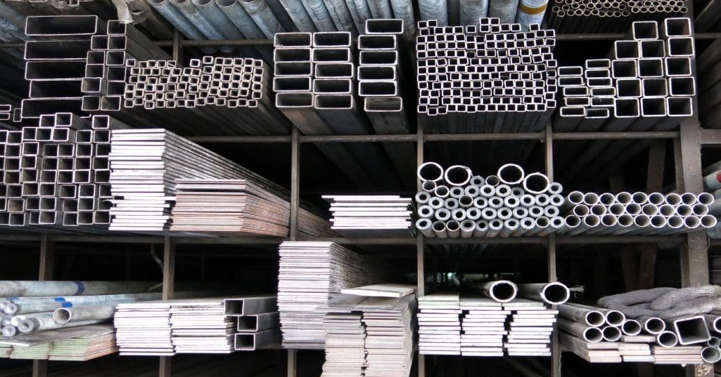 A large amount of metal pipes and tubes in the warehouse.